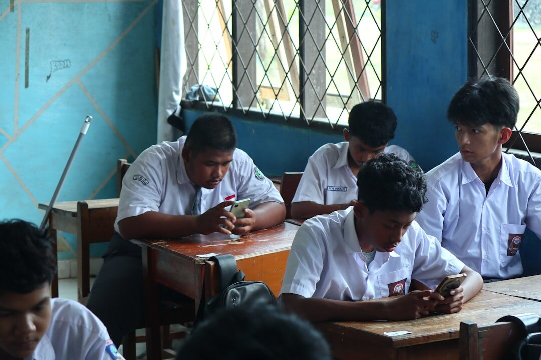 Modern classroom with students using laptops and tablets